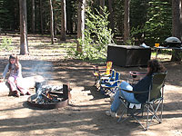 Bag chairs are inexpensive and much more confortable than the cold, hard ground