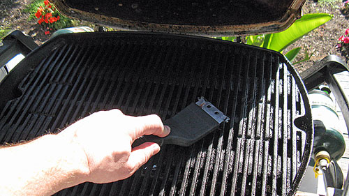 Cleaning the grate on the camping grill