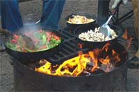Grilling fajitas over the campfire (photo by Jay Wilson on Flickr)