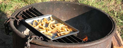 What's hamburgers and hotdogs without fries? We are toasting these over the campfire, while we grill the meat
