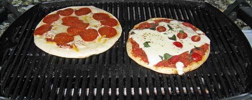 Grilling pizzas on one of our camping trips, this summer