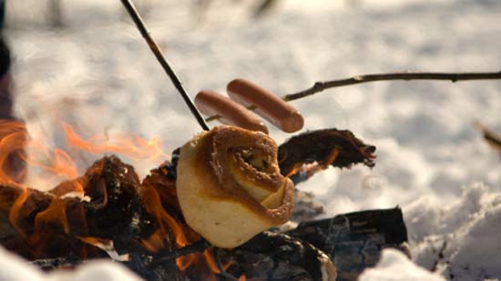 Grilling cinnamon rolls over the campfire